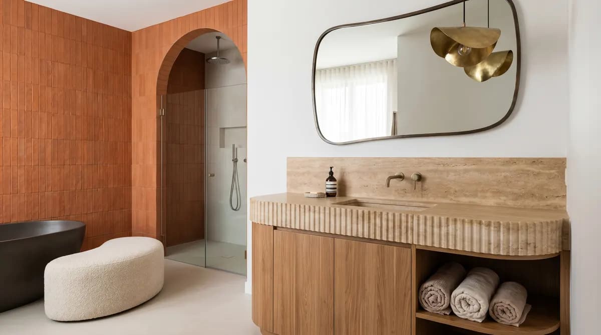 Floating oak vanity with a single-piece solid surface countertop and integrated sink.