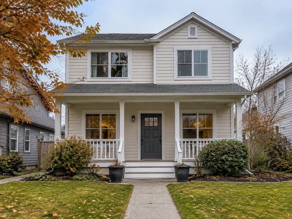 The front of a two-story house with a covered porch, before decorating