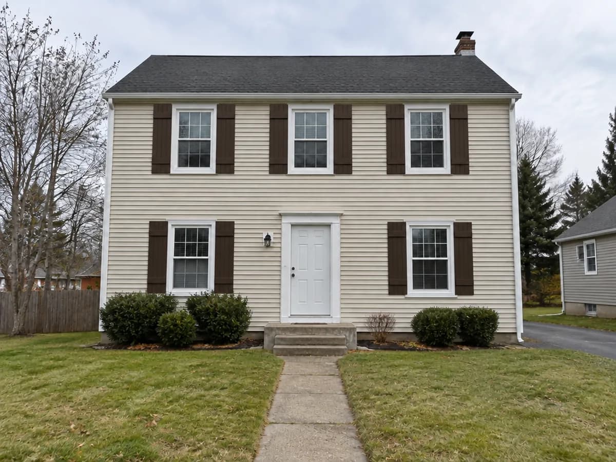The same house — Dark brown board & batten shutters
