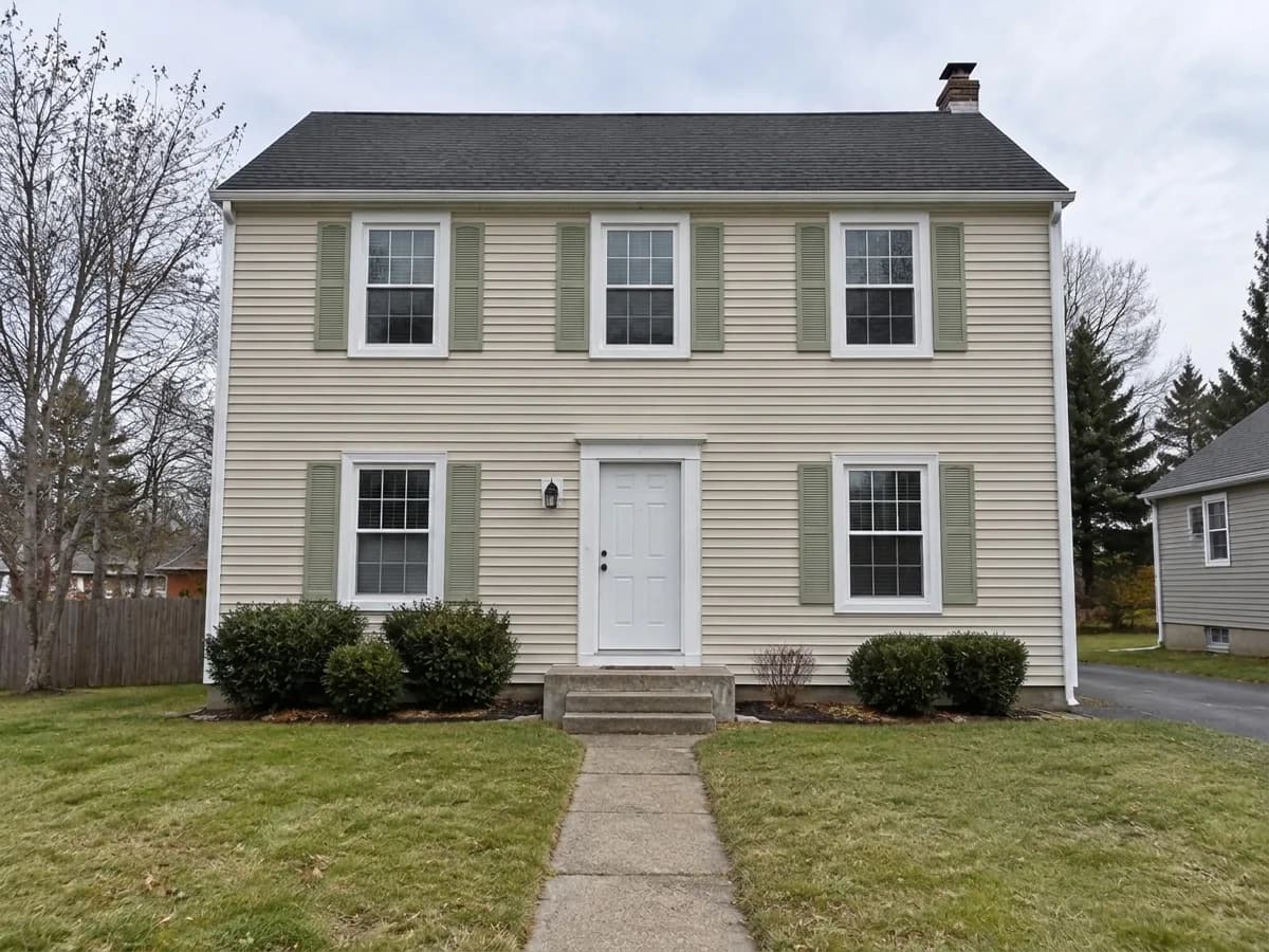 The same house — Sage green shutters